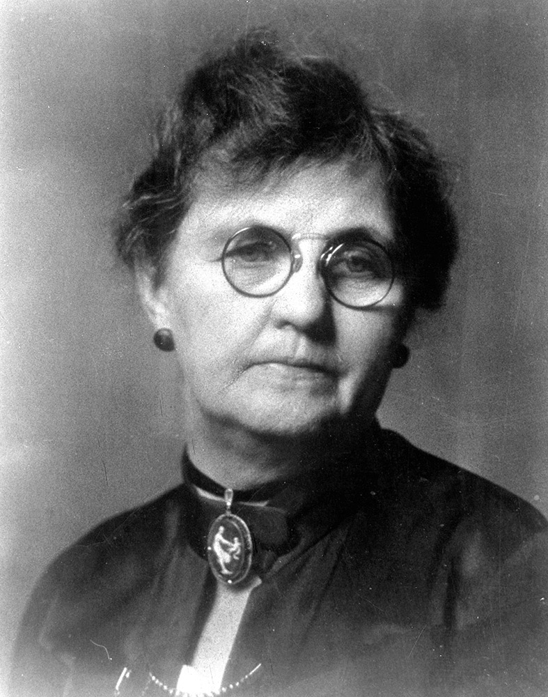 portrait of white woman in dress wearing glasses
