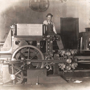 Men and machinery in newspaper office