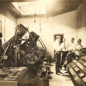 Men and machinery in newspaper office