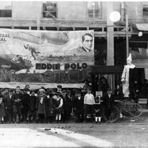 Large crowd of children in front of movie advertisement