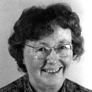 Head shot of white woman wearing glasses and smiling