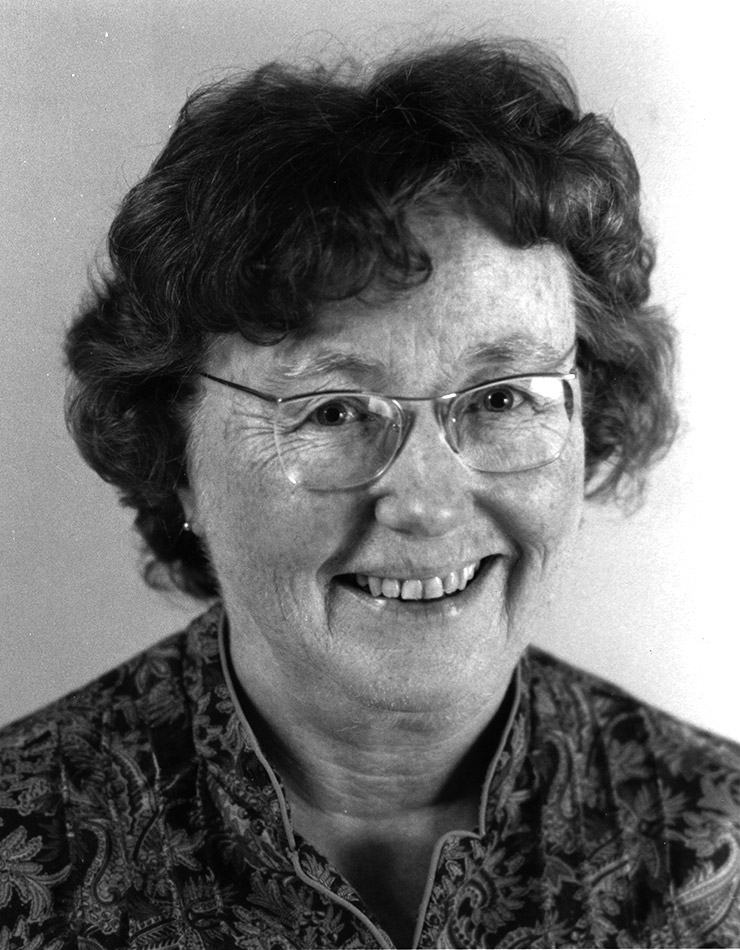 Head shot of white woman wearing glasses and smiling