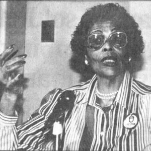 African American woman wearing glasses and gesturing with her hand
