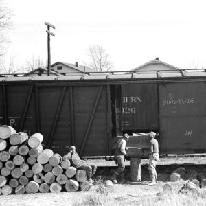 African American men loading logs onto train car