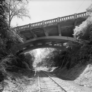 Concrete bridge spanning railroad tracks