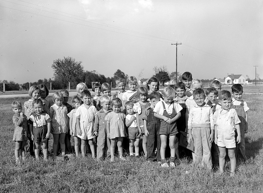 White children standing in field