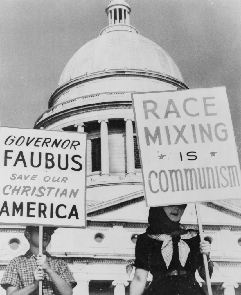 White people holding signs with "Race Mixing is Communism" and other slogans