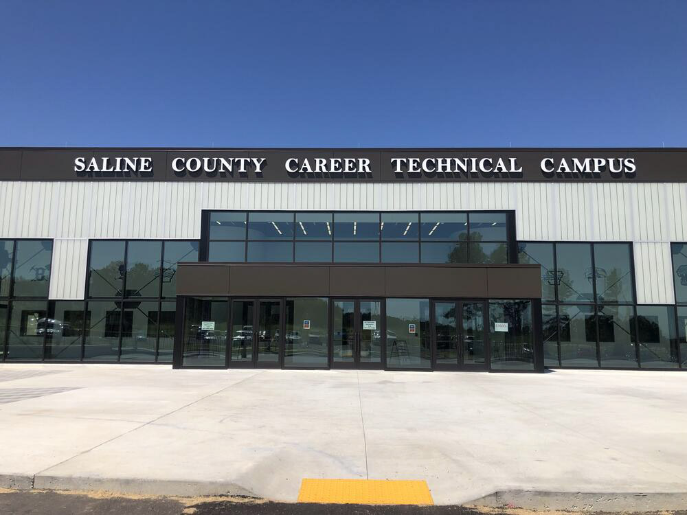 Multistory glass and metal building with letters across the top reading "Saline County Career Technical Campus"