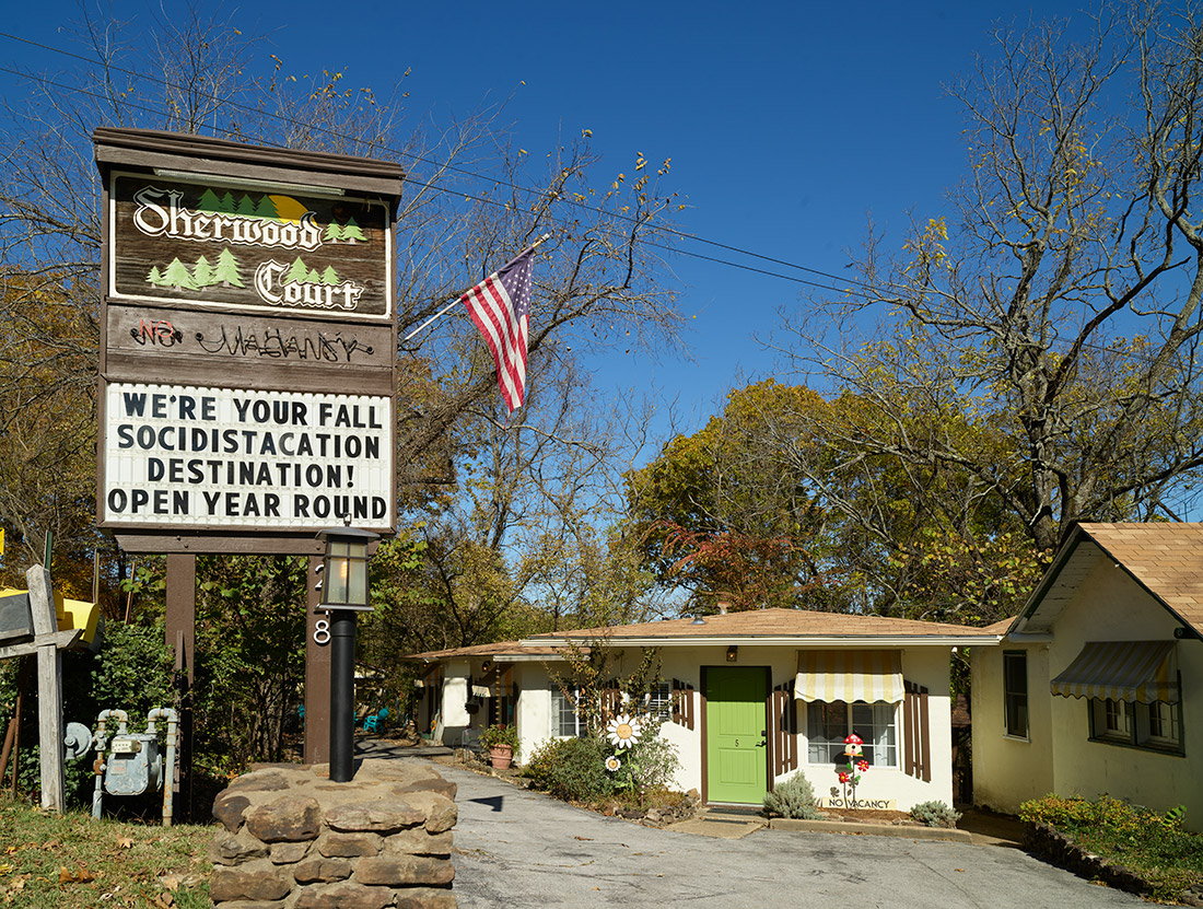 Single story buildings with large sign "Sherwood Court"