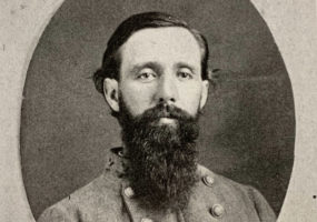 White man in military garb with beard