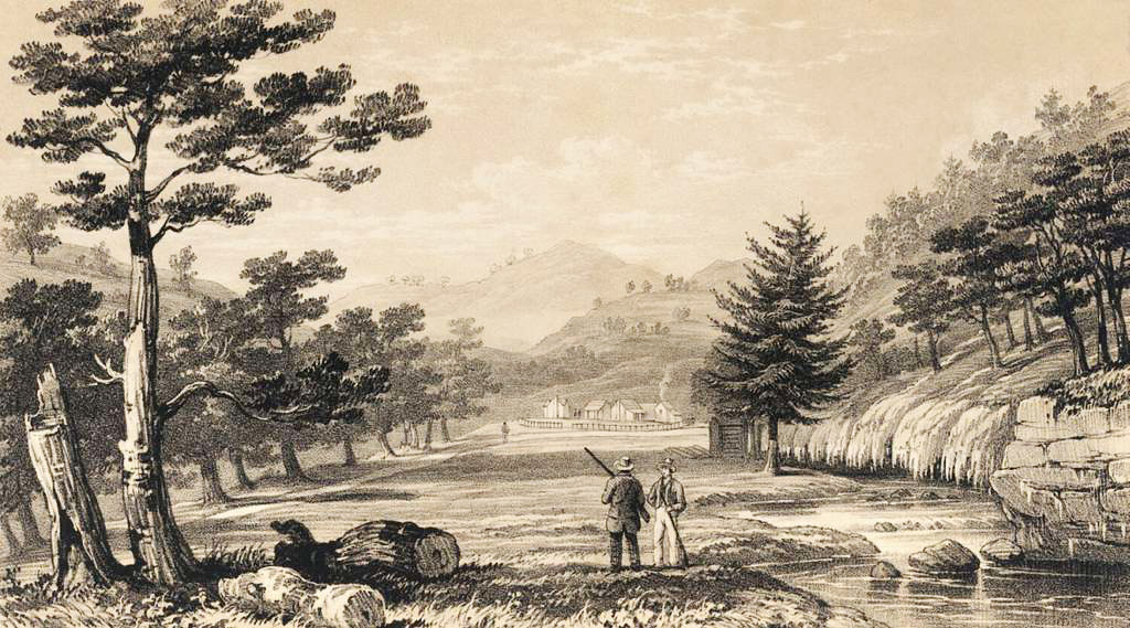 Two men standing in a valley looking into the distance