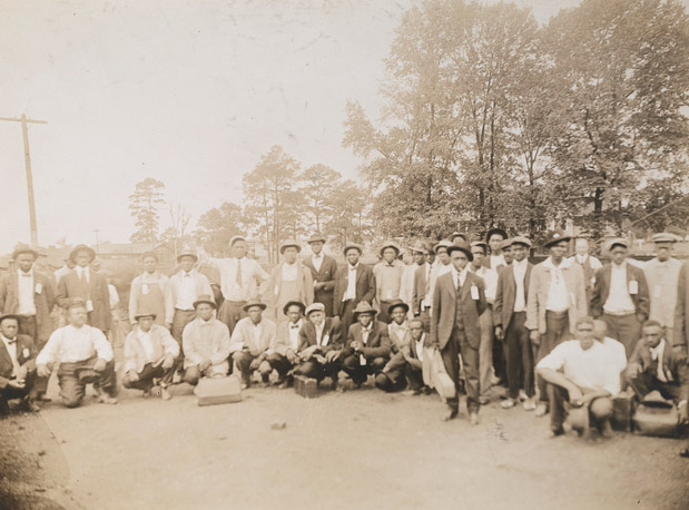 Large group of African American men posing in street