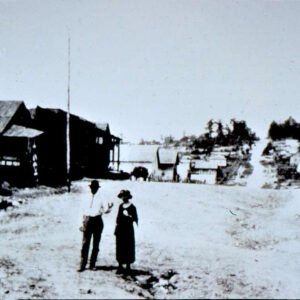 man and white woman standing in street in small town