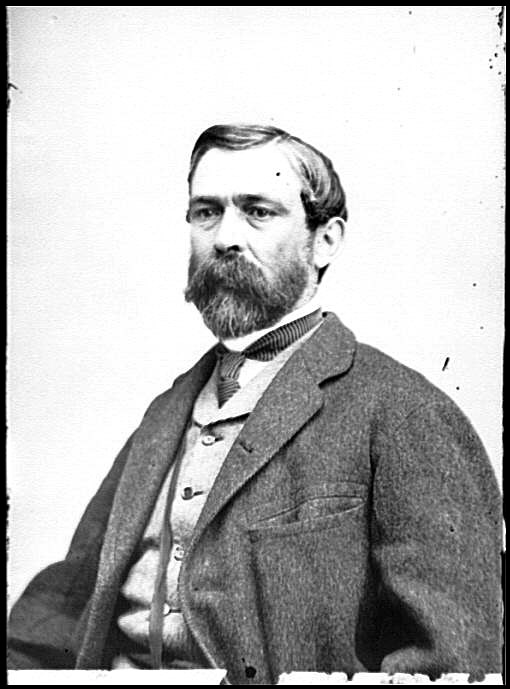 man in suit and tie with mustache and short beard