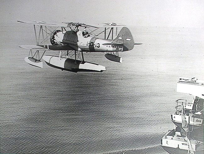 Military airplane flying over water