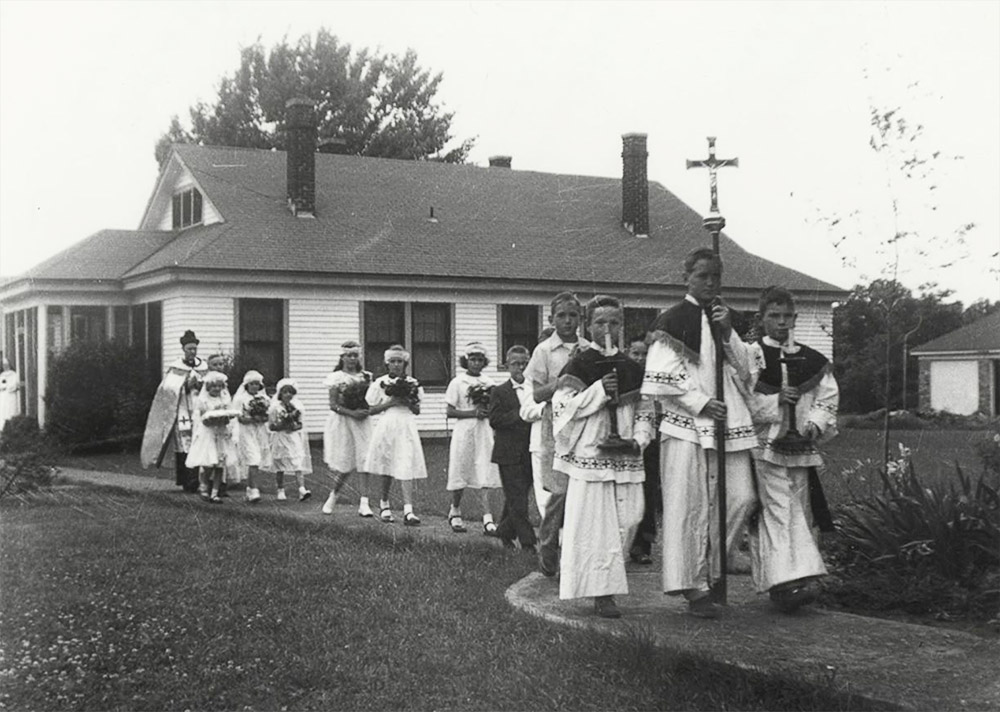 Priest and children walking away from church