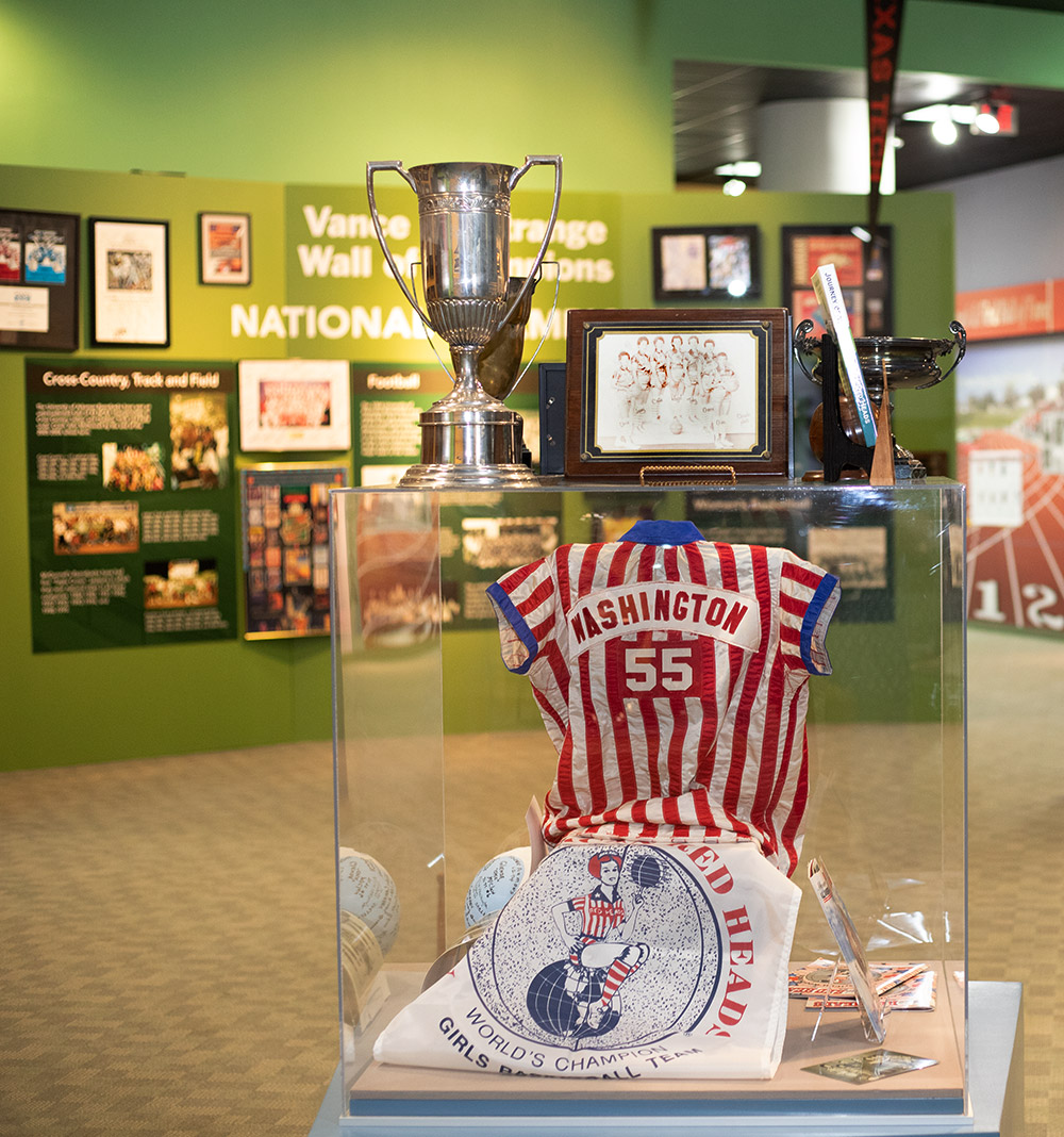 Display of red and white striped shirt and trophy