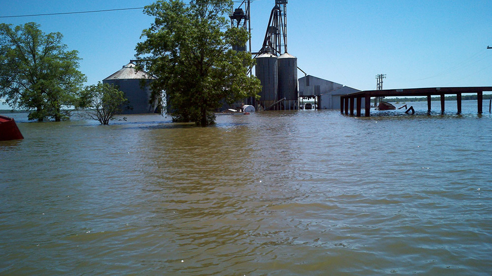 Metal buildings partially submerged by flood waters
