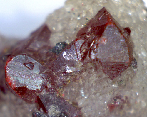 Rock with red crystals embedded