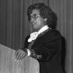African American woman in glasses standing at lectern
