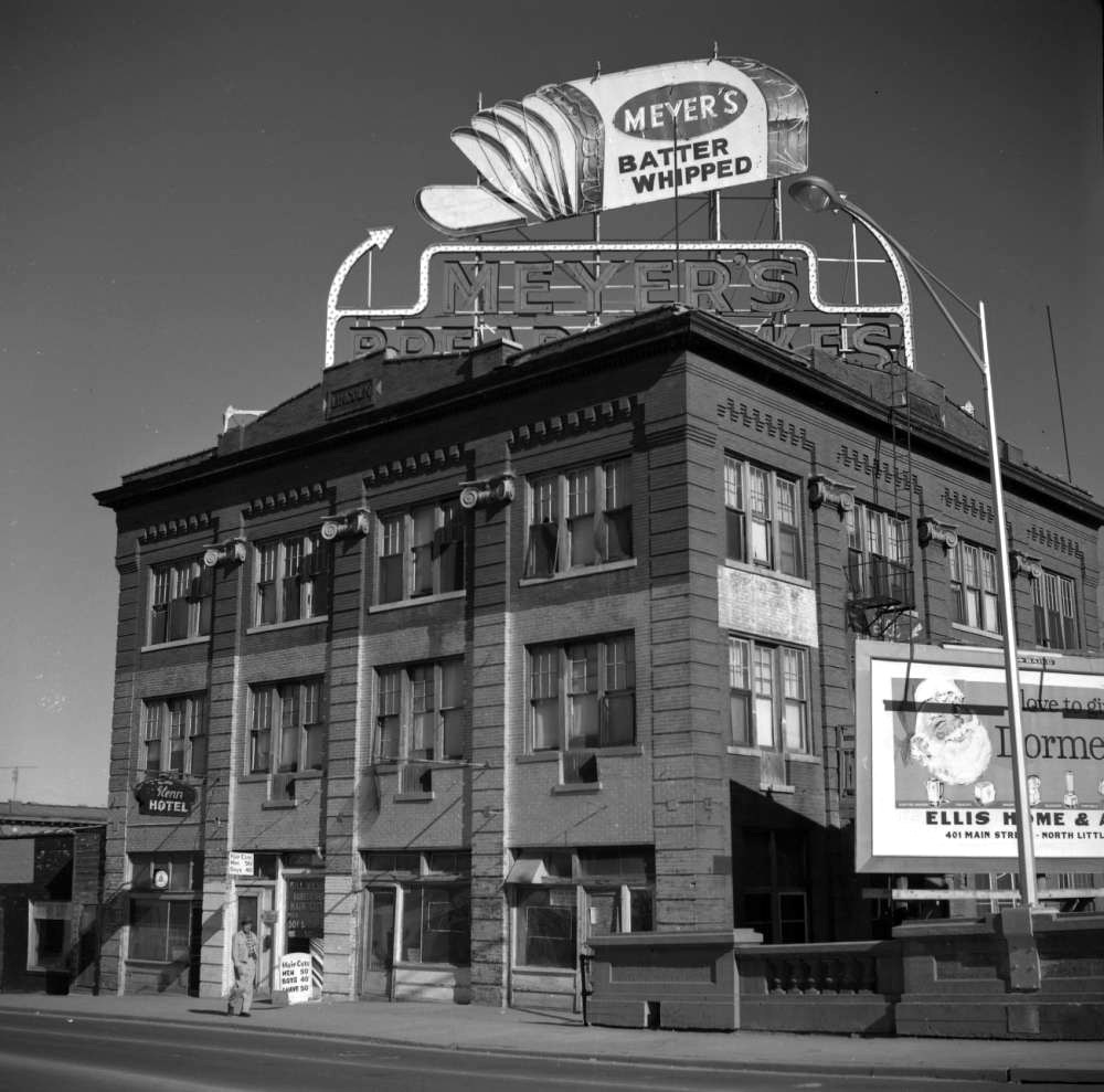 Multistory brick building with giant loaf of Meyer's bread on sign atop it