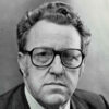 Head and shoulders of white man wearing glasses