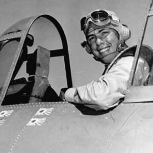 White man sitting in airplane cockpit and smiling