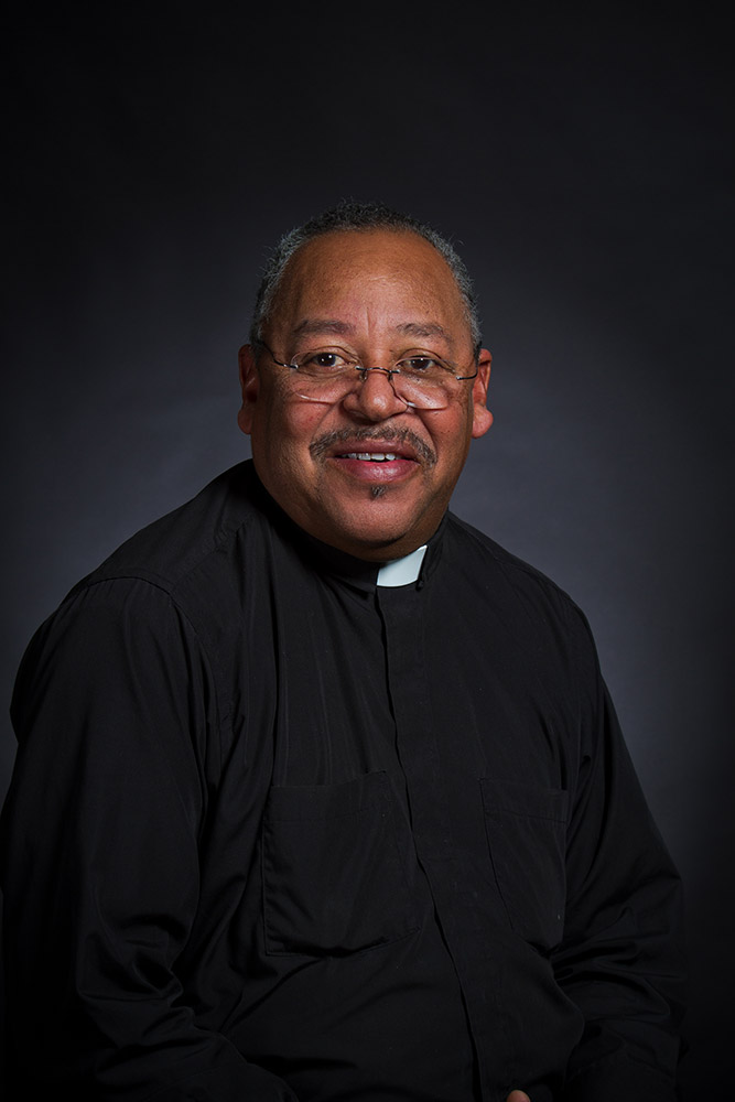 African American man in glasses and priest's frock