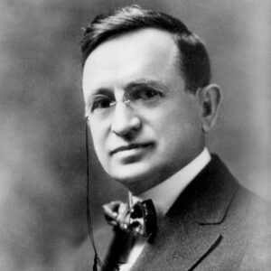 White man in bow tie and pince-nez glasses