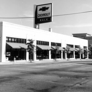 Multistory white building with sign on top saying "Bale Chevrolet"
