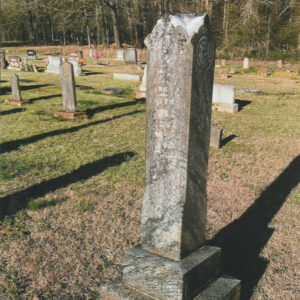 Stone pillar gravestone in graveyard