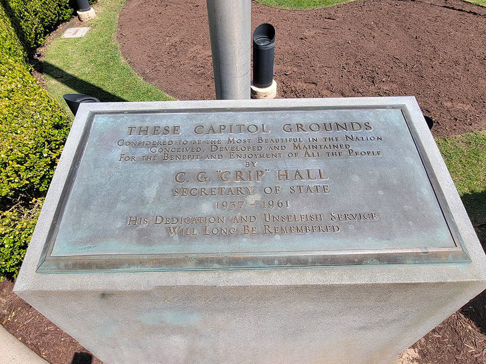 Plaque atop concrete block with dedication to Secretary of State C. G. "Crip" Hall