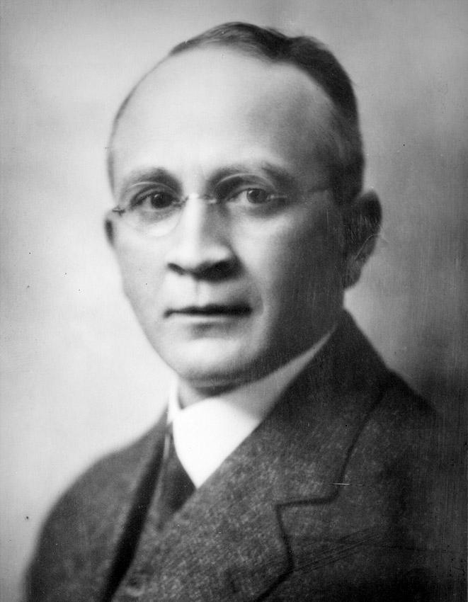 White man in suit and tie and glasses