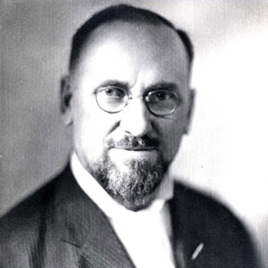 White man with beard and glasses