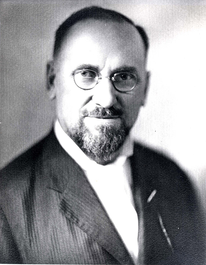 White man with beard and glasses