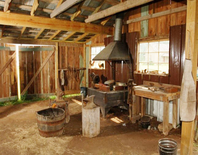 Interior of wooden work building showing many tools and implements