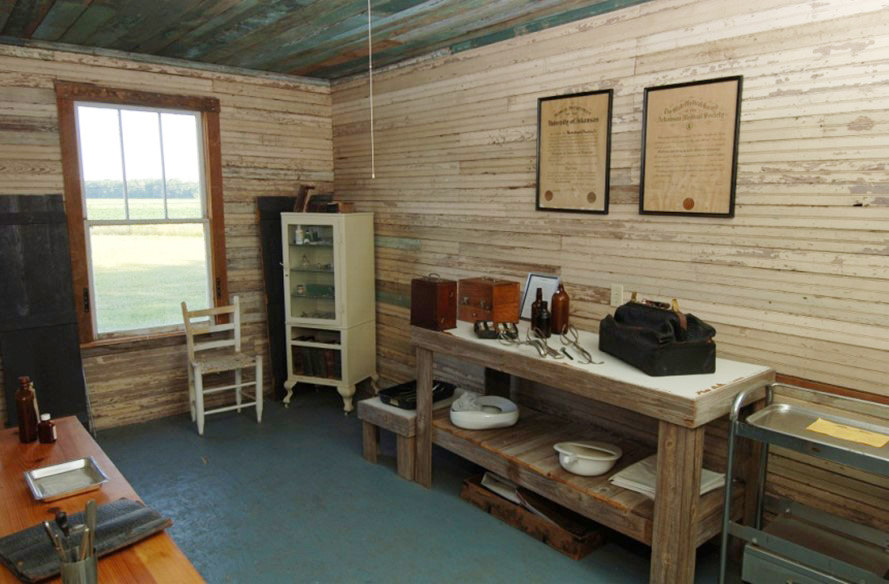 Interior room of wooden building with medical implements on table