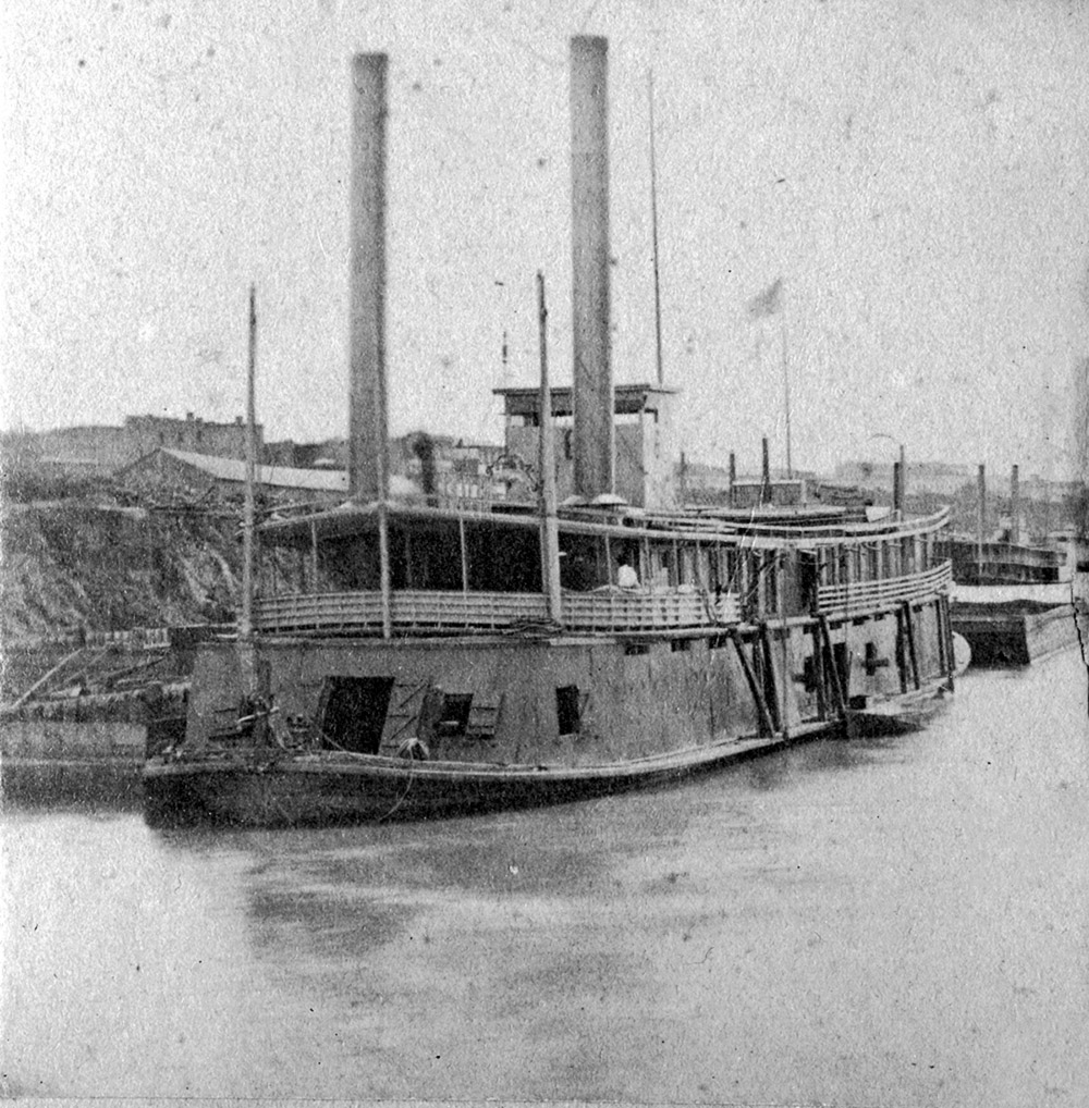 Side-wheel paddle steamboat moored at bank
