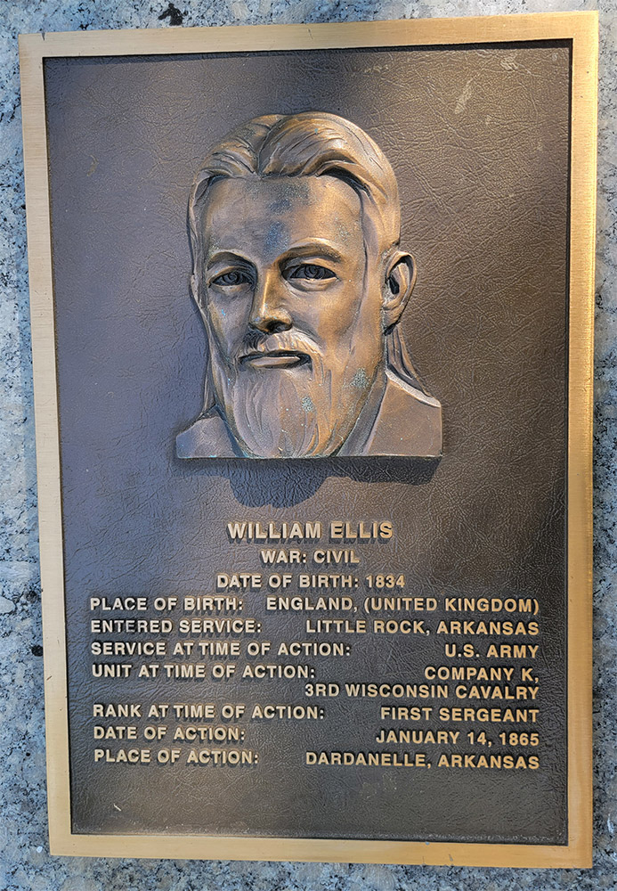 Man's face on bronze plaque