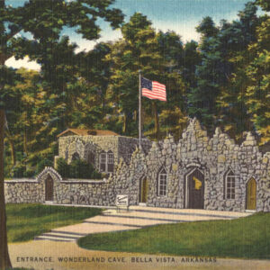 Rock building with American flag surrounded by trees