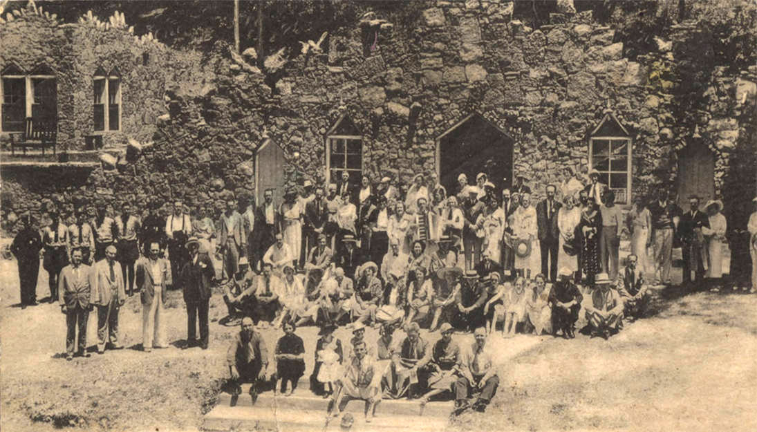 Large crowd of people in front of rock building