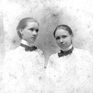 Two white young women in matching outfits