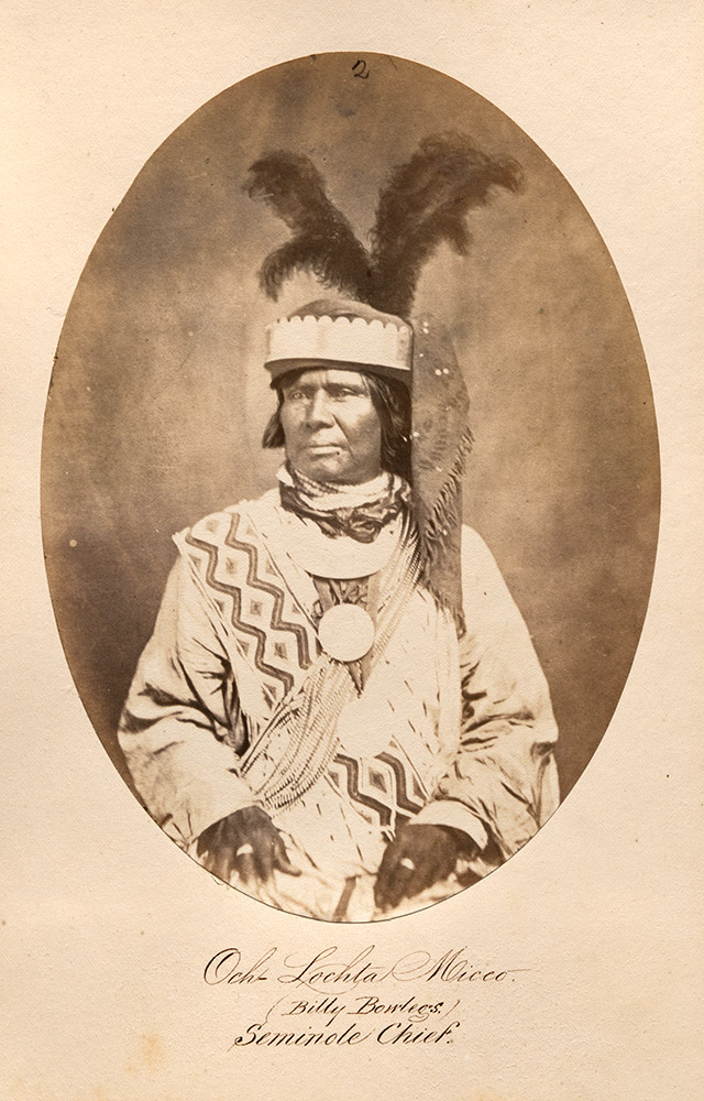 Native American man in traditional garb and headdress