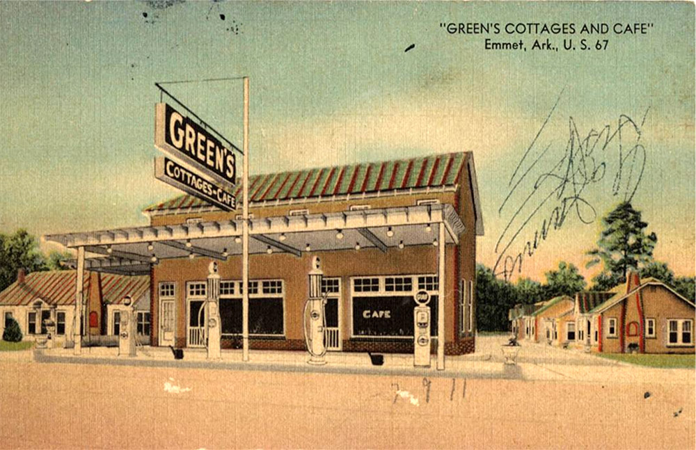 light brown building with gas pumps in front and small cottages to the side