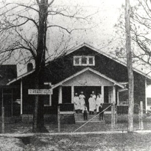 buildings with medical staff standing on porch
