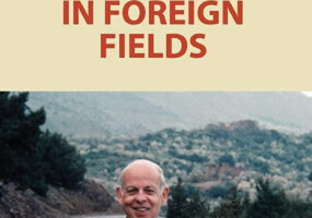 Book cover picturing an older man in a sweater standing on a road in a hilly area