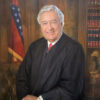 White man in tie and judge's robes