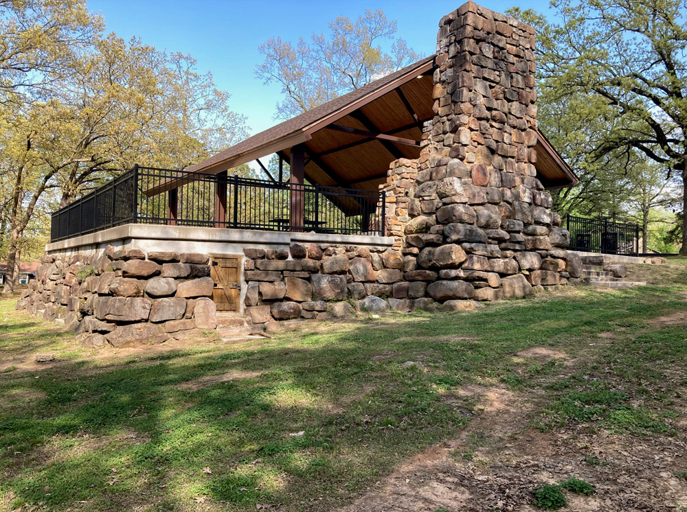 Stone and wood picnic shelter and back of fireplace