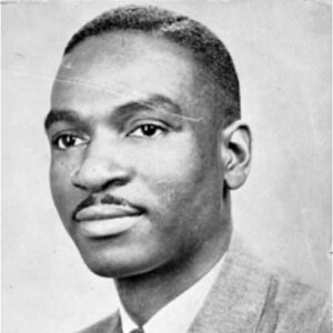 Young African American man with mustache in suit and tie