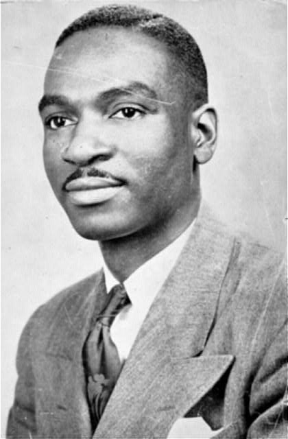 Young African American man with mustache in suit and tie